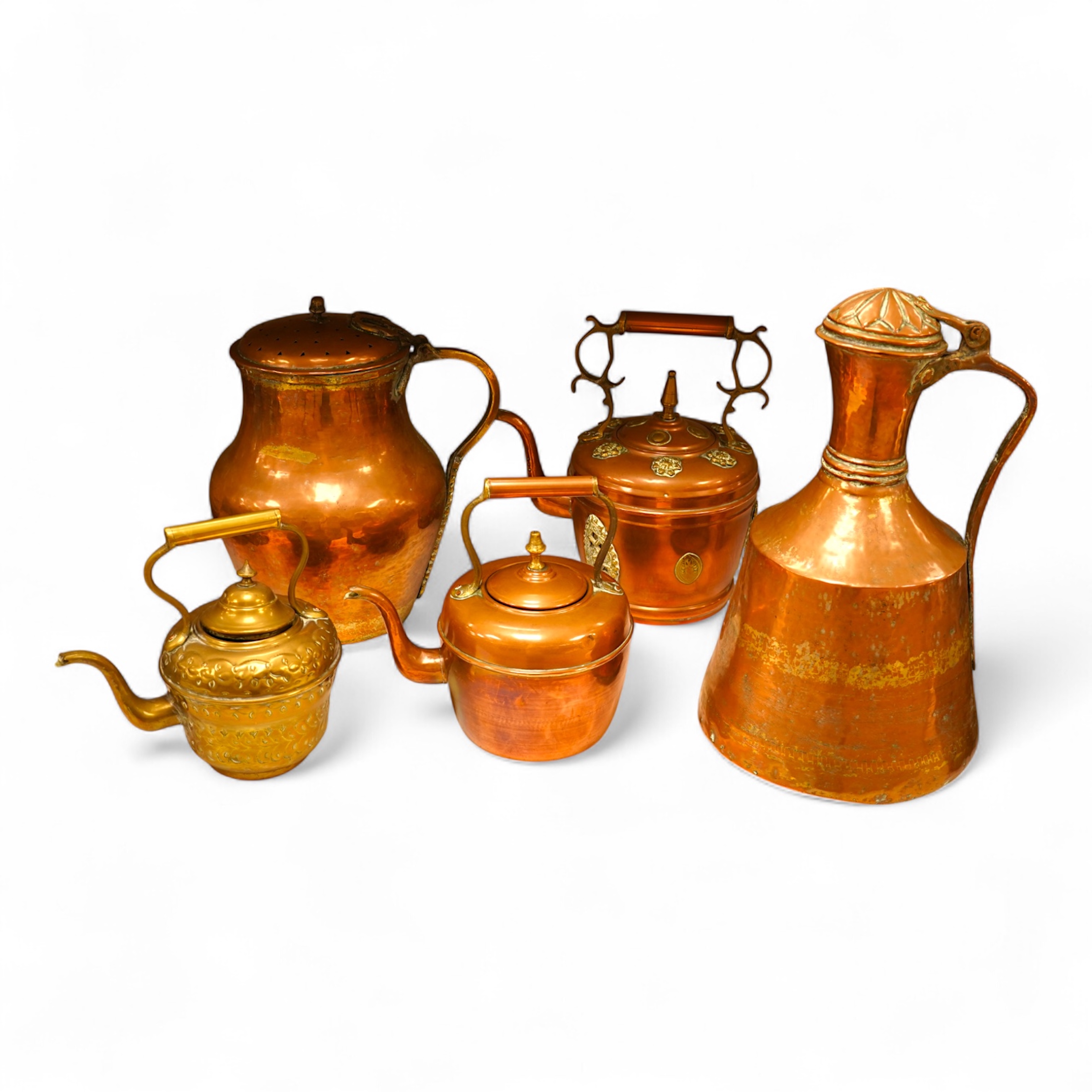 Four various copper vessels and a brass teapot, tallest 47cm